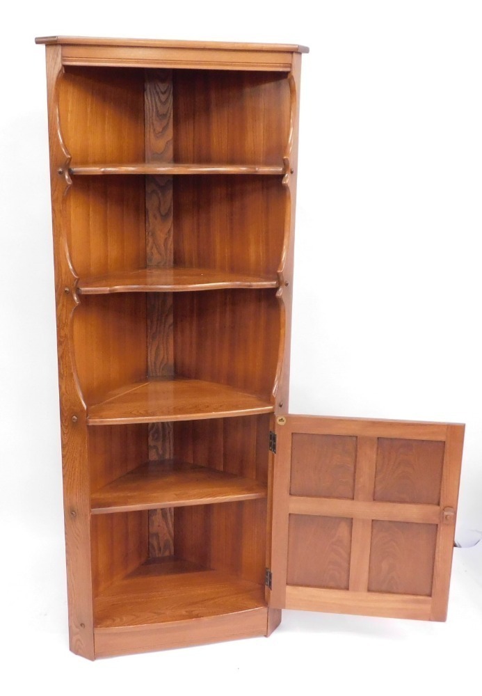 An Ercol light elm corner with three tiered shelf section