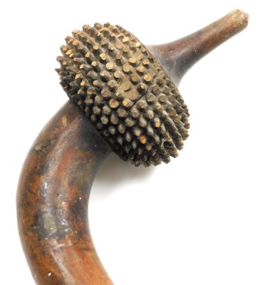 A 19thC Fijian Totokia (Pineapple) war club, of dense hardwood, the curved head carved with ten bands of hobnails, on a straight shaft terminating in a flared grip, 81cm wide. - 9