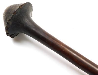 A 19thC New Caledonian Melanesia Kanak war club, of dense hardwood with a mushroom shaped phallic head, and a tapering cylindrical shaft, terminating in an expanded flange grip, 70cm wide. (AF) - 10