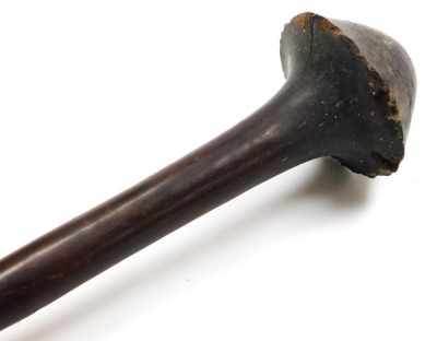 A 19thC New Caledonian Melanesia Kanak war club, of dense hardwood with a mushroom shaped phallic head, and a tapering cylindrical shaft, terminating in an expanded flange grip, 70cm wide. (AF) - 12