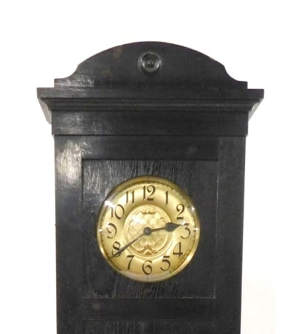 An early 20thC Continental Art Nouveau ebonised oak longcase clock, circular brass dial, with Arabic numerals, two train movement with coil strike, the case with a domed pediment, trunk with oval beveled glass plate, raised on bracket feet, with pendulum 