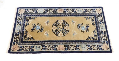 A Chinese rug, on a blue and cream ground with blossoms, white tassel ends, 133cm x 68cm.