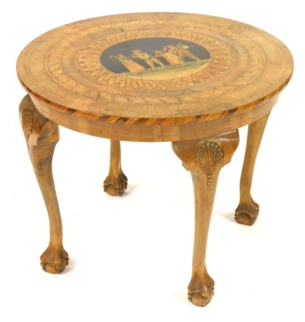 An Italian Sorrento coffee table, with boxwood stringing, and a marquetry central panel of four figures, on shell capped ball and claw feet, 48cm high, 60cm diameter.