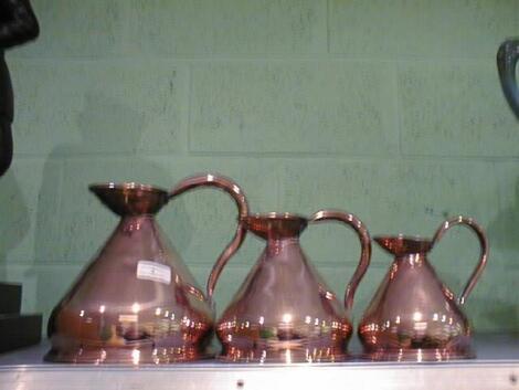 A set of 3 Victorian copper graduated Jug Measures of flared form