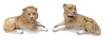 A pair of 19thC German porcelain lion and lioness figures, in the manner of Meissen, each recumbent with mouth open, in brown, their eyes picked out in black and yellow, unmarked, 12cm high. (2)