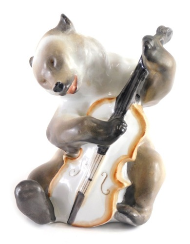 A 1940s Lomonosov porcelain figure of a polar bear playing cello, part of the famous quartet, printed mark and no. 166 beneath, 15cm high.