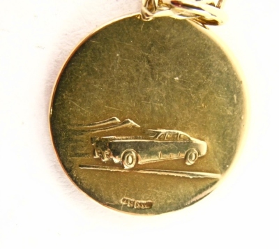 A St Christopher pendant and chain, the circular pendant with car model to reverse stamped 750 2½cm high, on a hammered curb link chain, 66cm long, yellow metal stamped 9kt, 8.4g all in - 4