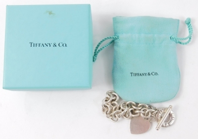 A charm bracelet, with curb linked charms, a heart shaped pendant, on single bar white metal stamped 925, 43.2g all in, in Tiffany and Co box. - 3