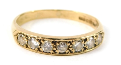 A 9ct gold diamond half hoop eternity ring, set with seven tiny diamonds, each in claw setting, approx 0.08ct, on a plain band, ring size Q½, 2.4g all in.