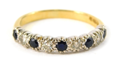 A 18ct gold sapphire and diamond half hoop dress ring, set five round brilliant cut sapphires and four round brilliant cut diamonds, each in a claw white gold setting, on a yellow metal band, ring O, 3.1g all in.