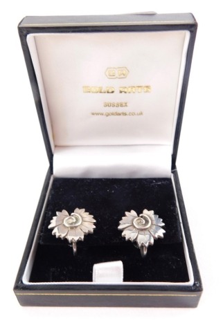 A pair of Georg Jenson silver earrings, each formed as a flower with twist centre, numbered 102 with screw off backs, 7g. boxed.