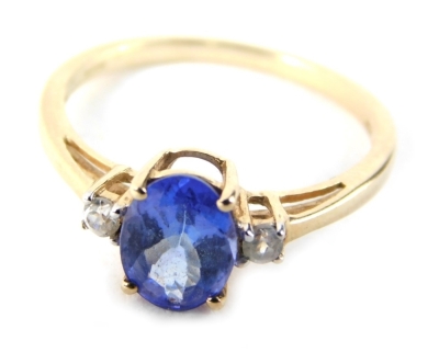 A three stone dress ring, set with oval topaz in four claw basket setting, flanked by two tiny diamonds, on a yellow metal band, marked 9ct but stamped 10k, ring size L½, 1.8g all in.