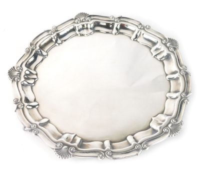 An Elizabeth II silver salver, by A Chick and Co, with pie crust edge broken by shells, on ball and claw feet, London 1965, 26cm wide, 18.5oz.