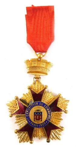 A medallion, Du Commerce Paris 1930, surmounted by a crown with ribbon, 9cm high.