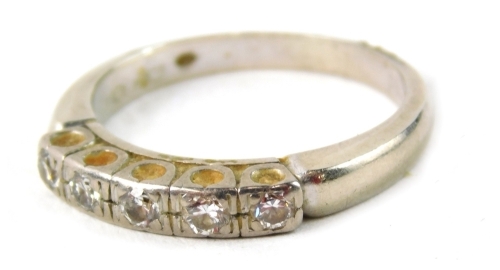 A diamond half hoop dress ring, set with five panels of tiny diamonds, each illusion set, approximately 0.37 carats overall, on a white metal band, unmarked, possibly platinum, ring size Q, 4.6g all in.