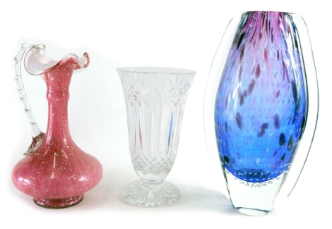 A Waterford Crystal vase, with bell shaped bowl, on circular foot, with a repeat hobnail cut decoration, 22cm high, a Continental bubble glass vase, in purple and white, and a pink glass ewer, with plain glass handle. (3)