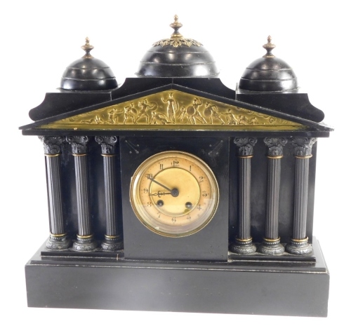 A Victorian black slate mantel clock, the 11cm diameter Arabic dial with eight day movement, flanked by six columns, in an architectural case, with classical figures surmounted by urns, with key and pendulum. 39cm high.