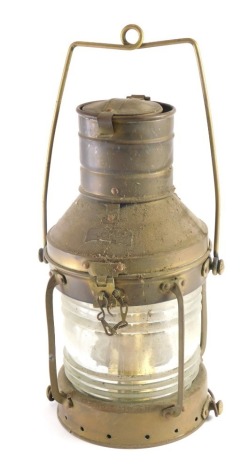 An early 20thC brass ships lantern, with swing handle, textured glazed front, with cylindrical top, the main body 40cm high.