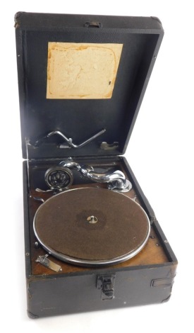 A mid 20thC tabletop gramophone, with chrome and baize lined turntable, chrome arm in pressed leather case, 17cm high.