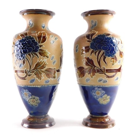 A pair of Royal Doulton Slaters Patent vases, each of shouldered form, decorate with flowers and a brown and blue ground, with raised bead borders on circular bases impressed marks beneath. 33cm high (2)