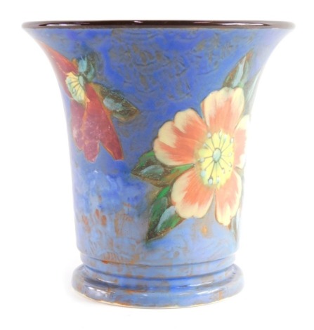 A Royal Doulton vase, D6227 decorated with flowers on a blue ground, printed marks beneath, 15cm high.