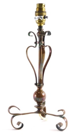 An early 20thC copper lamp, in the manner of W.A.S Benson, with plain cylindrical stem and S scroll supports on triple legs terminating in scroll feet, 37cm high.