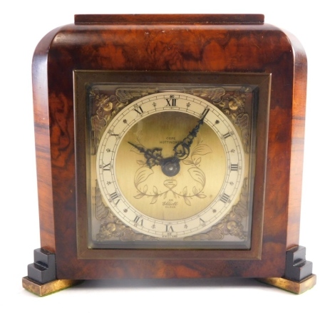 An Elliott London walnut cased mantel clock, with 9cm wide Roman numeric dial, with spandrels, in a shaped case, with hand wind movement, marked G and F Cope to the face and back 18cm high.