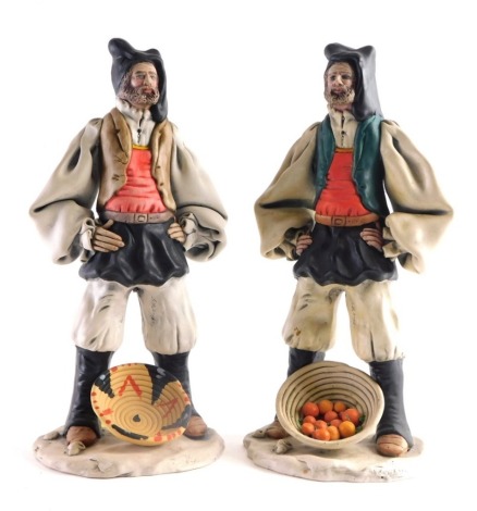 A pair of Raffaello Sanfilippo matt finished figures, each in flowing robes, stood behind baskets, one containing oranges, marked beneath, 35cm high. (2)