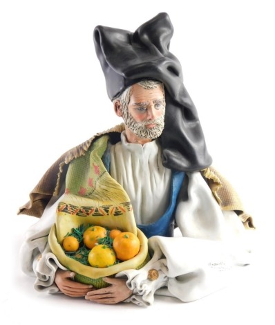 A Raffaelo Sanflippo matt figure of a gentleman, quarter profile holding basket of basket of oranges, polychrome decorated, impressed marks. 32cm high.