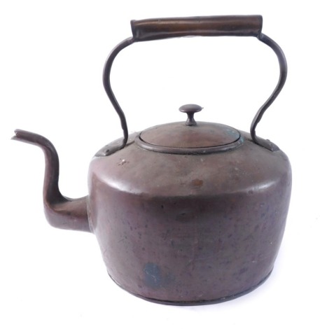 An early 20thC copper kettle, of unusually large proportion, with fixed handle and shaped spout with plain body, 40cm high.