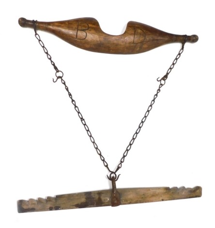 A late 19thC wooden yoke, with iron chain, 87cm long, and another.