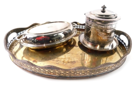 A Victorian silver plated biscuit barrel, of cylindrical form with hinged lid on fixed base, 20cm high, an entree dish with beaded outline and a tray. (3)
