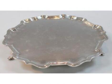 A George VI large pie crust edge salver with three hoof feet