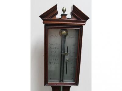 A Georgian mahogany cased stick barometer with broken arch pediment and acorn finial