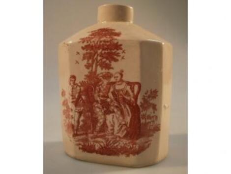 An 18thC creamware tea canister with iron red transfer scenes of Harlequin