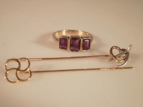 A three stone amethyst set 9ct gold dress ring and two stick pins