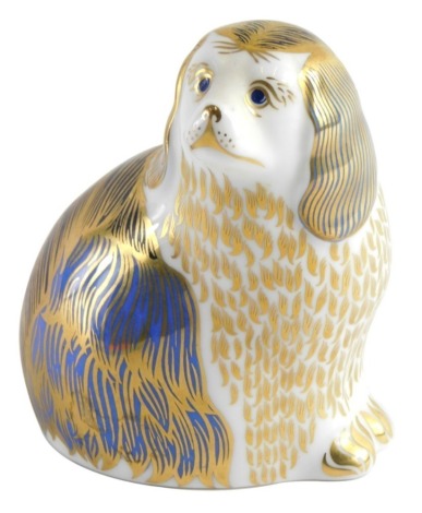 A Royal Crown Derby paperweight ornament king Charles spaniel, printed marks beneath, gilt stopper, 10cm high.