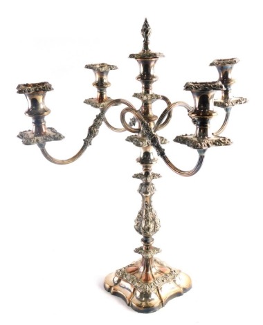 A late 19th/early 20thC silver plated four branch candelabrum, with flame finial, on turned acanthus leaf stem, repousse decorated enriched with further scrolls and flowers, on a shaped base, with four sconces, each with inverted dish holders, 55cm high.