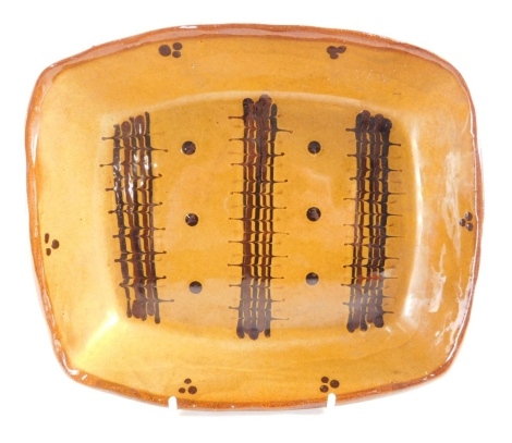 An 18thC style slipware dish, of oval form, with a repeat central geometric pattern, unmarked, 23cm wide.