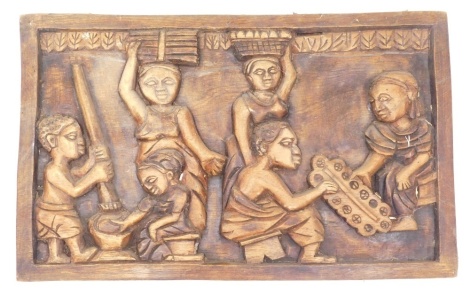 An African tribal style wall hanging heavily carved with many figures, 41cm high, 62cm wide, 3cm deep.