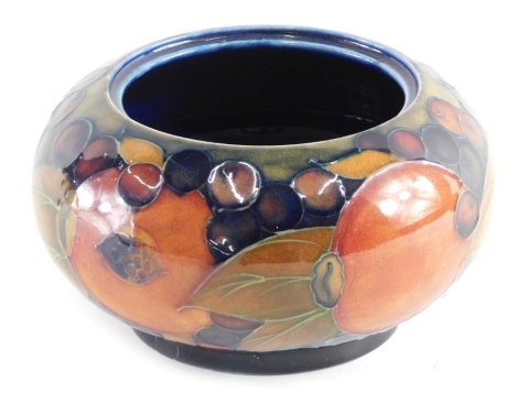 A 20thC Moorcroft Pomegranate pattern bowl, of globular form, on circular foot, impressed and painted marks beneath, 9cm high, lacking cover.