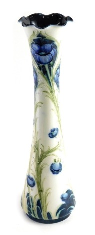 An early 20thC William Moorcroft Florian ware vase, with flared rim and inverted stem, on circular foot, printed and signature mark beneath, 32cm high.