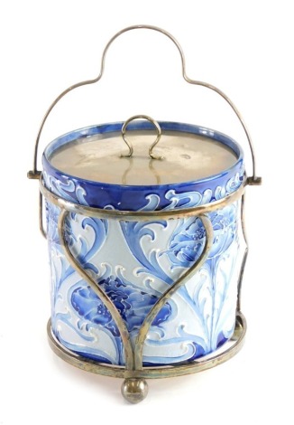 An early 20thC Moorcroft Florian ware biscuit barrel, with silver plated stand and removable lid, on orb feet, decorated with flowers, impressed marks beneath, 24cm high.