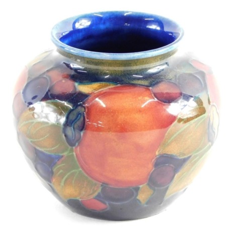 An early 20thC Moorcroft Pomegranate pattern vase, of globular form, on blue ground, impressed marks beneath, 8cm high.