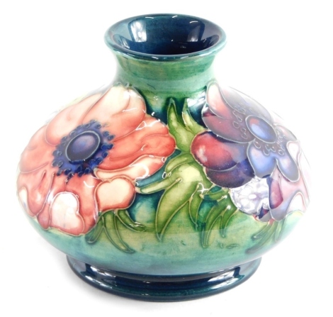 A Moorcroft Anemone pattern vase, of globular form on circular foot, on green ground, impressed marks beneath, 10cm high,