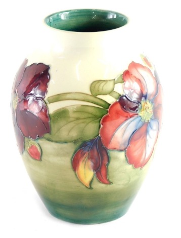 A 20thC Moorcroft floral vase, on cream ground, impressed marks beneath, 20cm high.