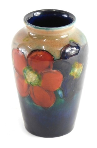 A Moorcroft pottery Anemone vase, of shouldered form, on a blue and fawn ground, impressed marks beneath, 10cm high.